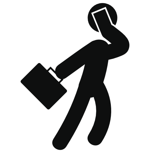 Businessman walking with a suitcase and talking by phone