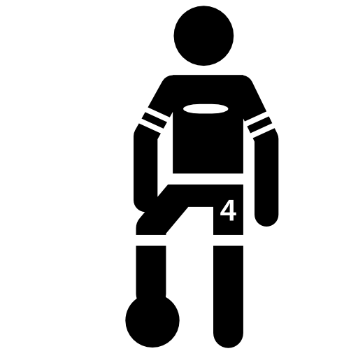 Soccer player standing with the ball under one feet
