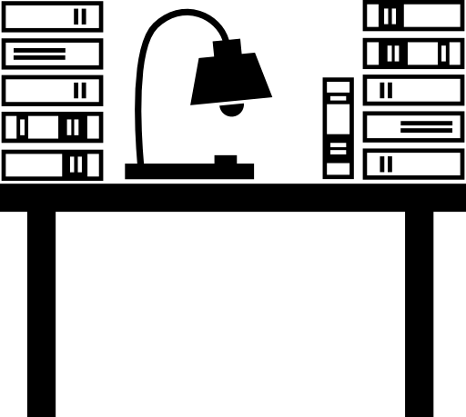 Class desk of teacher with a lamp and books stacks