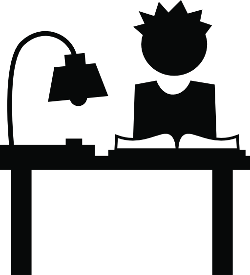 Student studying on his desk with a lamp and a book