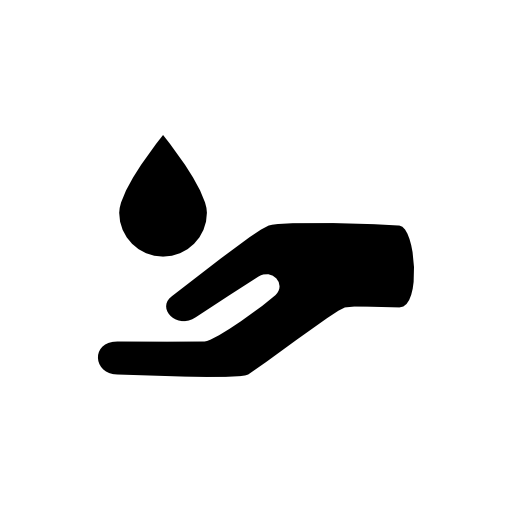 Essential oil drop for spa massage falling on an open hand